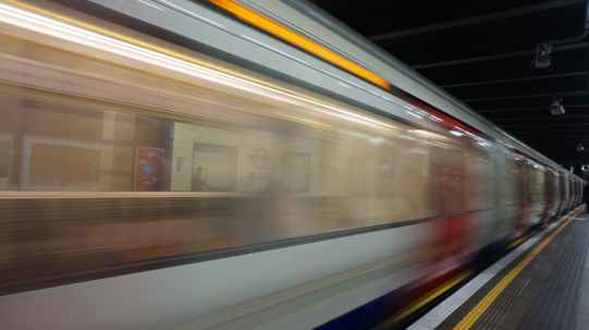 blurred motion of train at railroad station